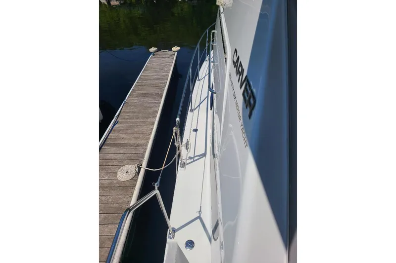 Slide: The Image of 2003 Carver 356 Aft Cabin Motor Yacht docked beside wooden pier. - 26