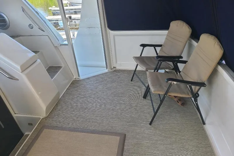 Slide: The Image of 2003 Carver 356 Aft Cabin Motor Yacht interior with folding chairs and carpeted floor. - 27