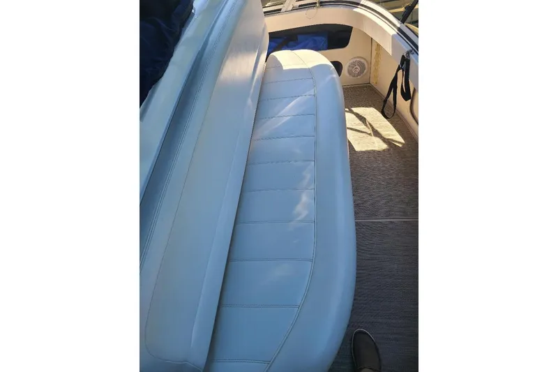 Slide: The Image of 2003 Carver 356 Aft Cabin Motor Yacht interior seating with blue upholstery. - 29