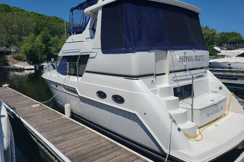 Slide: The Image of 2003 Carver 356 Aft Cabin Motor Yacht docked at a marina. - 3