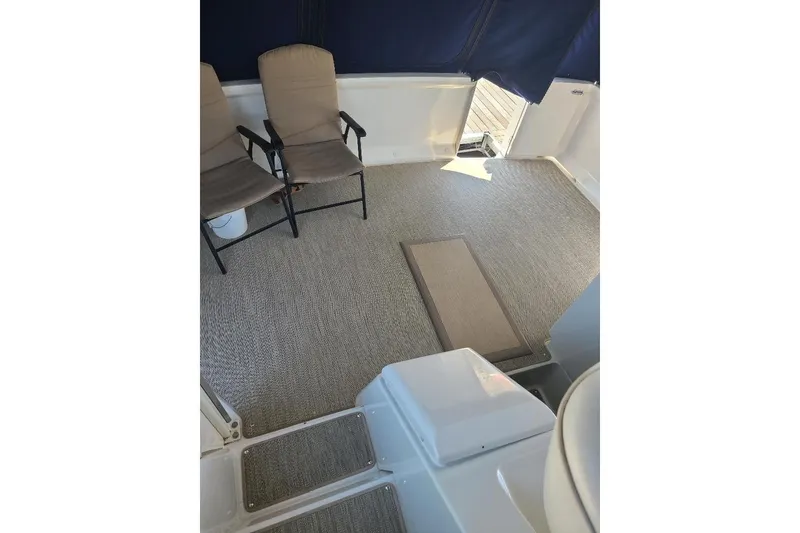 Slide: The Image of 2003 Carver 356 Aft Cabin Motor Yacht interior with chairs and carpeted floor. - 30