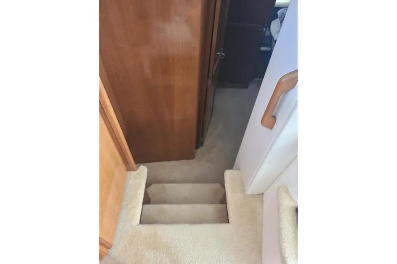 Slide: The Image of Interior stairs of 2003 Carver 356 Aft Cabin Motor Yacht with wooden paneling. - 5