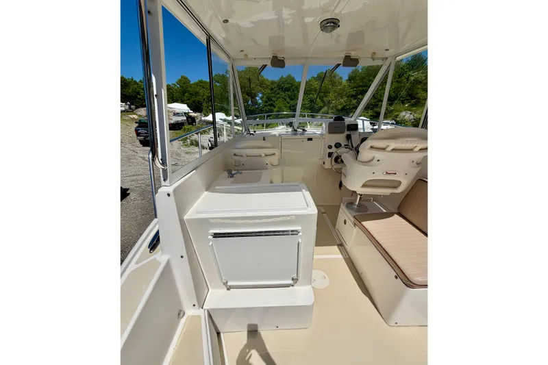 Slide: The Image of 2007 NorthCoast 235 HT boat interior with helm, seating, and storage. - 13