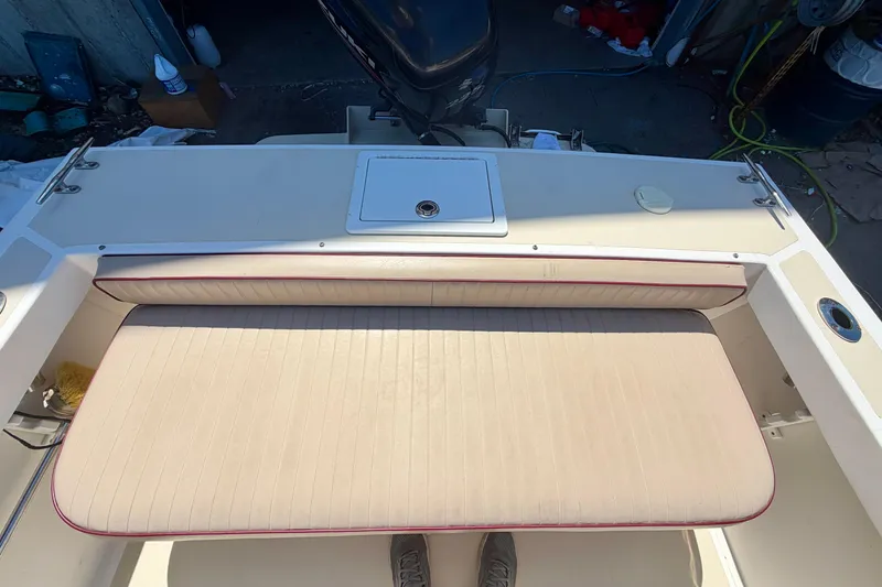 Slide: The Image of 2007 NorthCoast 235 HT boat interior with cushioned seating and storage compartment. - 16