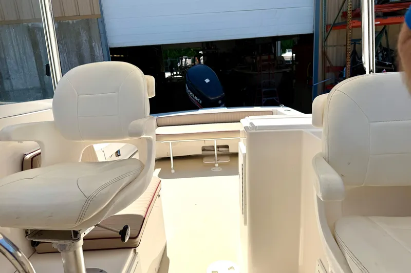 Slide: The Image of Interior view of a 2007 NorthCoast 235 HT boat with white seating. - 17
