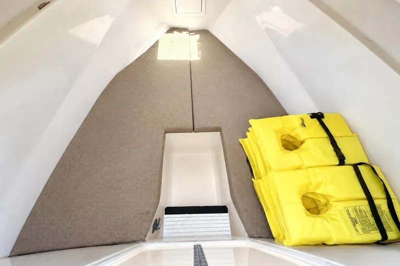 Slide: The Image of Interior cabin of 2007 NorthCoast 235 HT boat with yellow life jackets. - 18