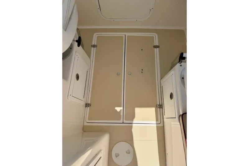 Slide: The Image of Interior view of a 2007 NorthCoast 235 HT boat cabin with storage compartments. - 19