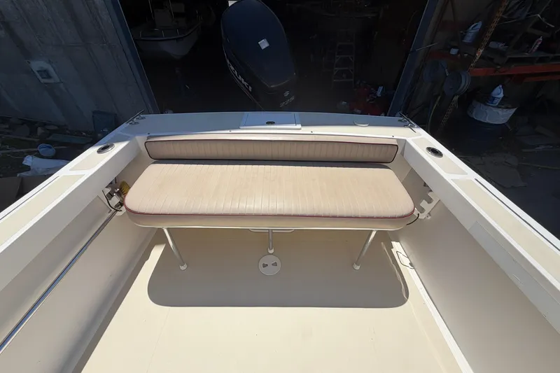 Slide: The Image of 2007 NorthCoast 235 HT boat interior with cushioned seating and outboard motor. - 20