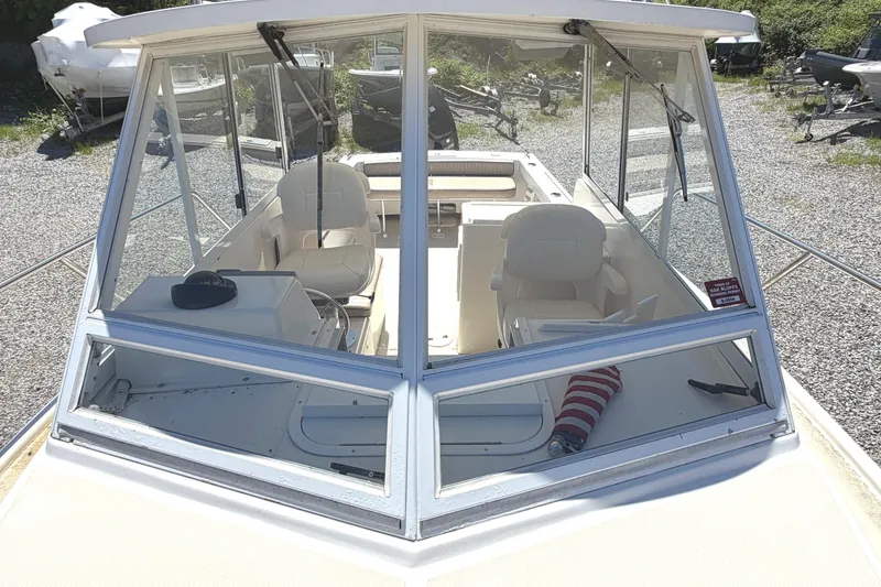 Slide: The Image of 2007 NorthCoast 235 HT boat with spacious cockpit and seating, parked on gravel. - 22