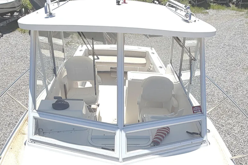 Slide: The Image of 2007 NorthCoast 235 HT boat interior with helm and seating area. - 23