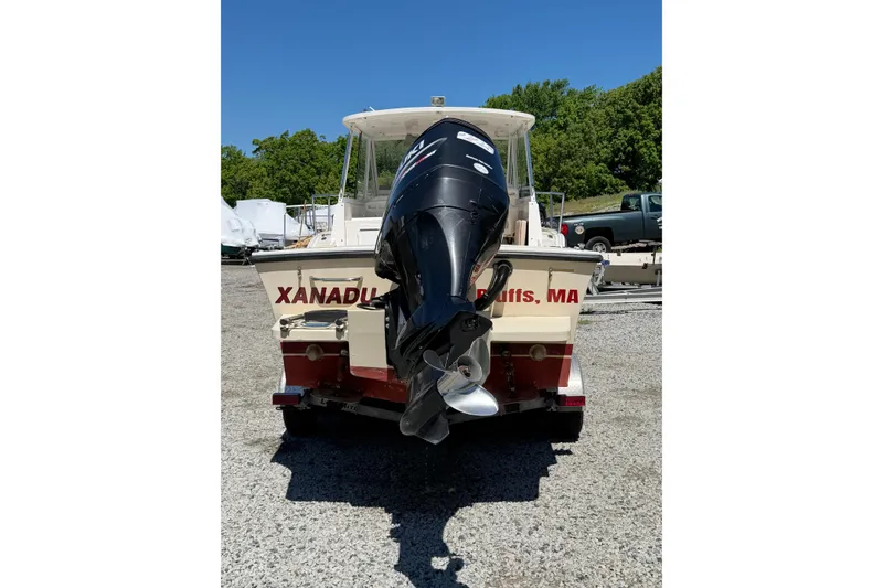 Slide: The Image of 2007 NorthCoast 235 HT boat with outboard motor, parked on gravel, sunny day. - 25