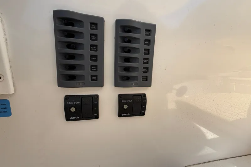 Slide: The Image of Control panel of a 2007 NorthCoast 235 HT boat with switches and bilge pump controls. - 26