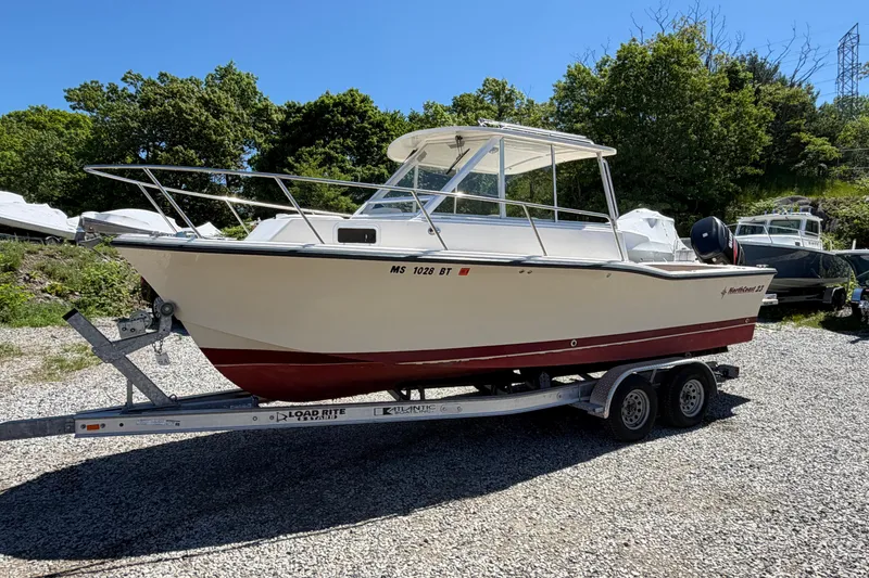 Slide: The Image of 2007 NorthCoast 235 HT boat on trailer, parked outdoors on gravel. - 4