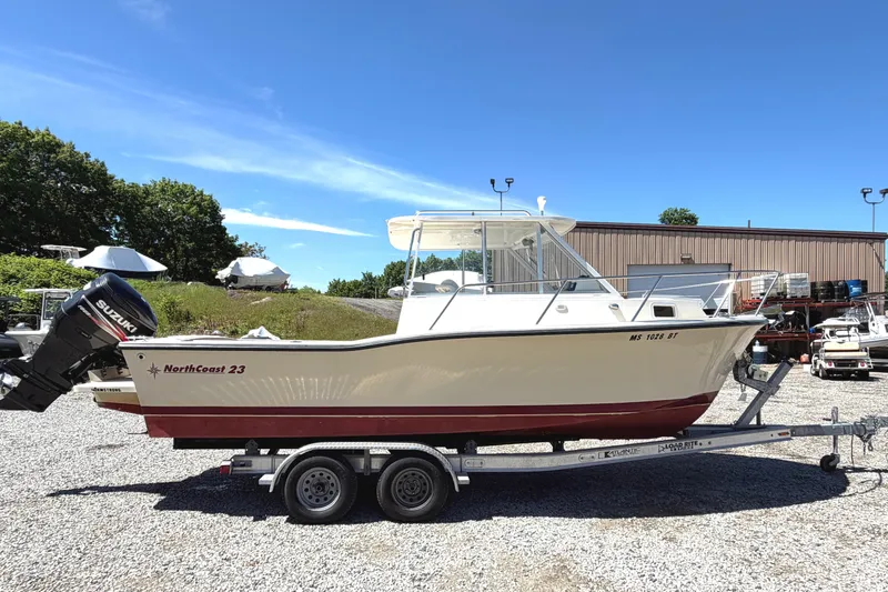 Slide: The Image of 2007 NorthCoast 235 HT boat on trailer, outdoors, with Suzuki outboard motor. - 5