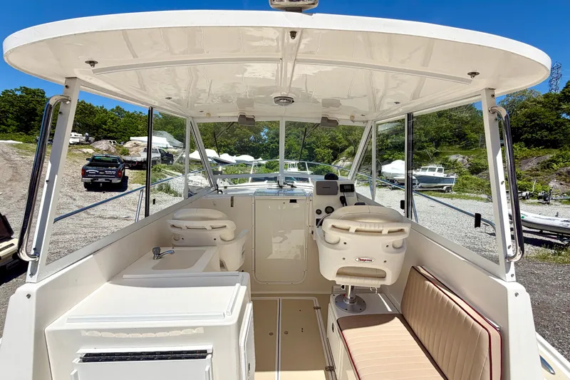 Slide: The Image of 2007 NorthCoast 235 HT boat interior with helm, seating, and clear canopy. - 7