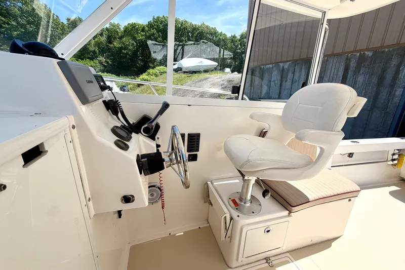 Slide: The Image of 2007 NorthCoast 235 HT boat interior with captain's chair and steering console. - 9