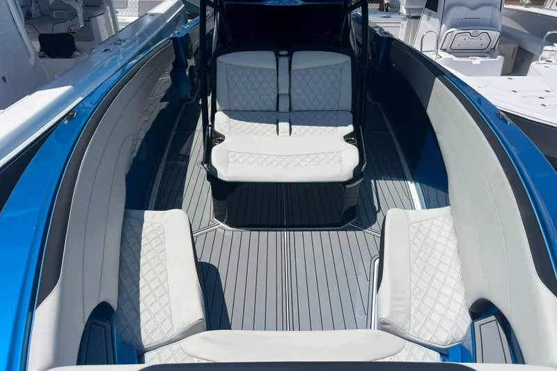 Slide: The Image of 2021 Nor-Tech 340 Sport Center Console with luxurious seating and sleek blue design. - 13