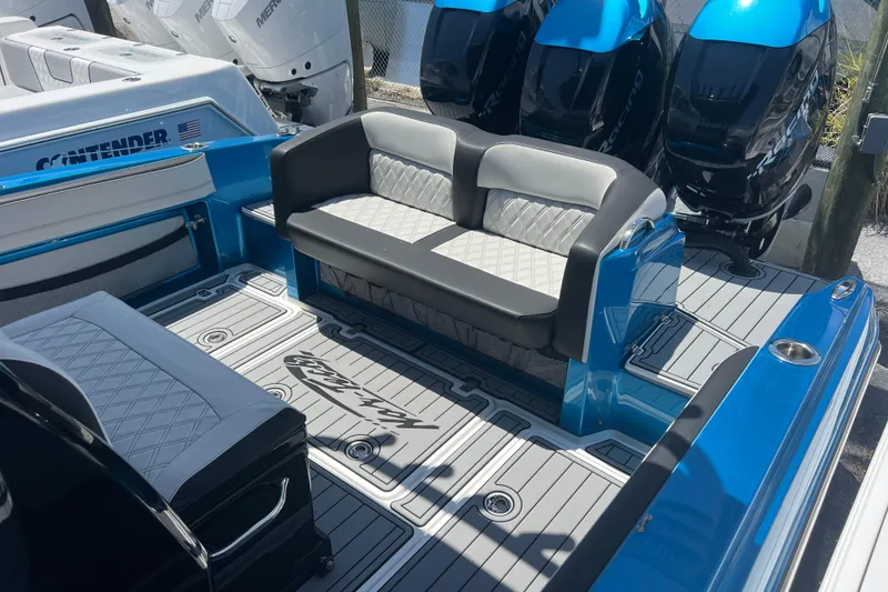 Slide: The Image of 2021 Nor-Tech 340 Sport Center Console boat interior with seating and powerful engines. - 15