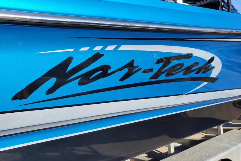 Slide: The Image of Blue 2021 Nor-Tech 340 Sport Center Console boat with bold logo. - 5
