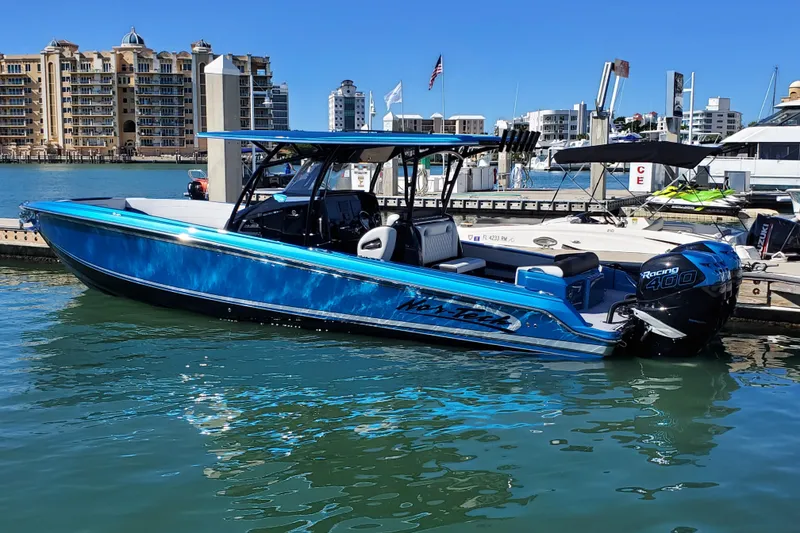 Slide: The Image of 2021 Nor-Tech 340 Sport Center Console boat docked in marina, blue exterior. - 7