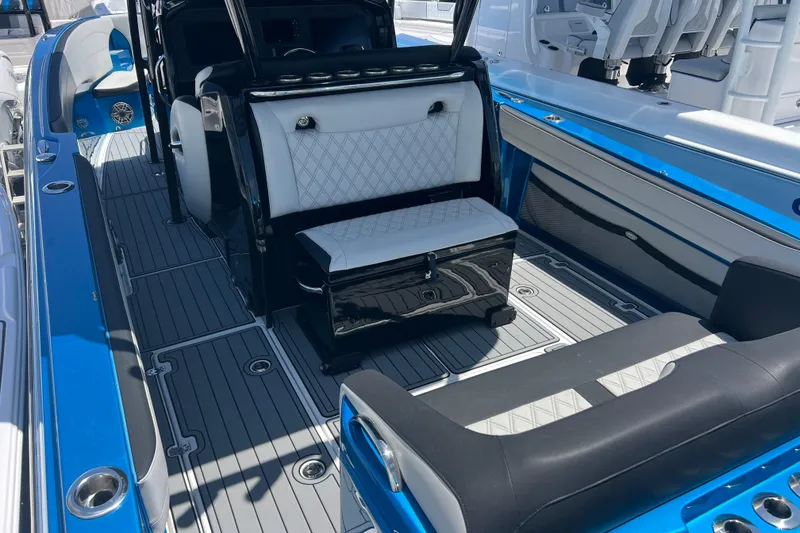 Slide: The Image of 2021 Nor-Tech 340 Sport Center Console interior with blue accents and luxury seating. - 9