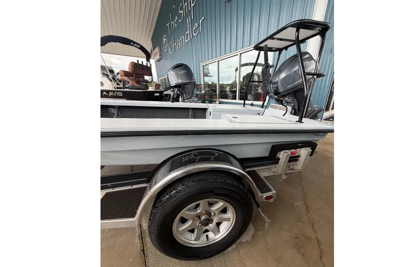 Slide: The Image of 1999 Hell's Bay boat on trailer, featuring Yamaha outboard motor, parked at The Ship Chandler. - 3