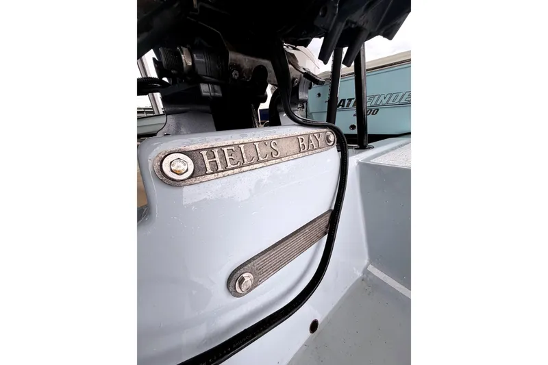 Slide: The Image of Close-up of a 1999 Hell's Bay boat detail with logo and hardware. - 4