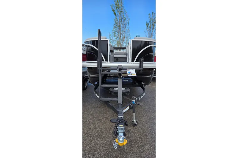 Slide: The Image of 2026 Sun Tracker Party Barge 22 RF DLX on trailer, rear view, parked outdoors. - 2