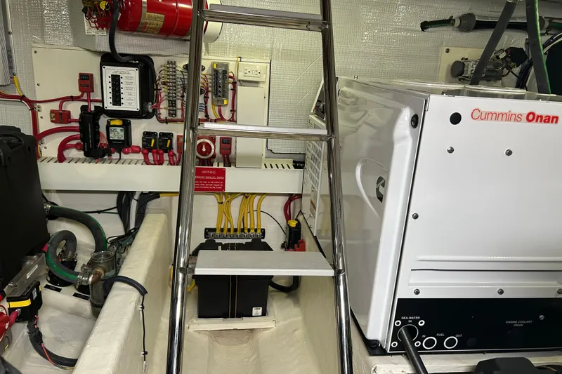 Slide: The Image of Engine room of 2016 Sabre 42 Salon Express with Cummins Onan generator and electrical panel. - 13
