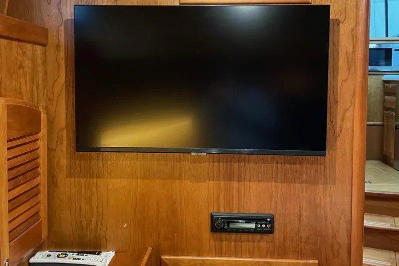 Slide: The Image of Flat-screen TV and audio system in 2016 Sabre 42 Salon Express yacht interior. - 8