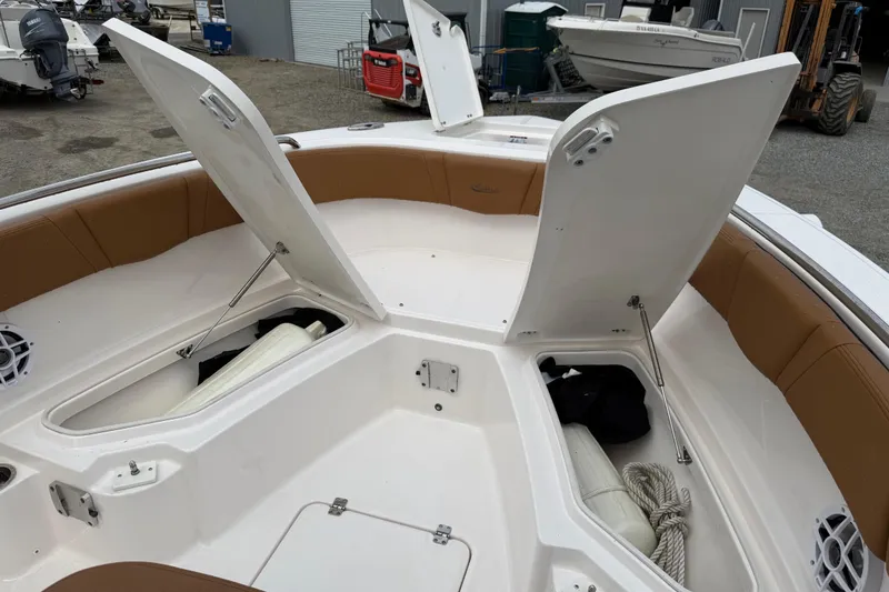 Slide: The Image of 2025 Robalo R232 Explorer with open bow storage compartments. - 12
