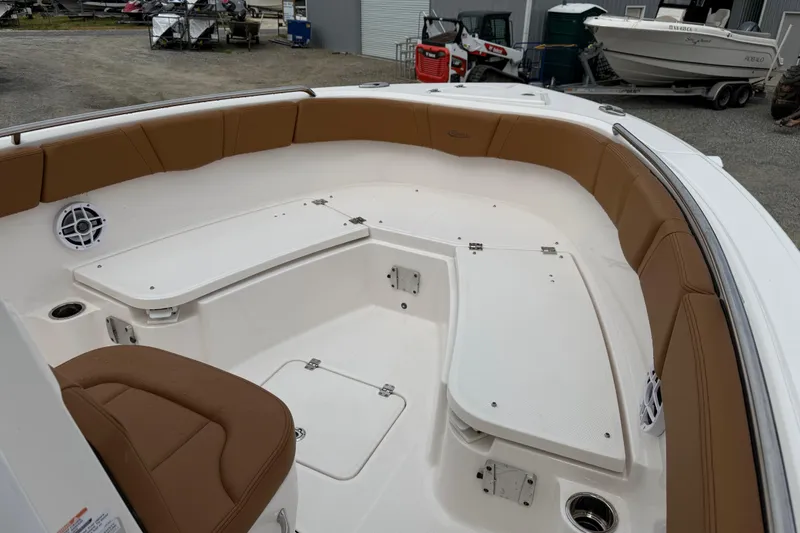Slide: The Image of Interior view of 2025 Robalo R232 Explorer with brown seating. - 13
