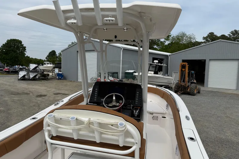 Slide: The Image of 2025 Robalo R232 Explorer boat parked outdoors. - 14
