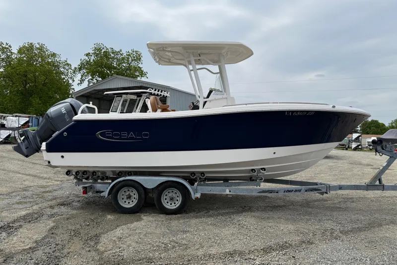 Slide: The Image of 2025 Robalo R232 Explorer boat on trailer outdoors. - 3