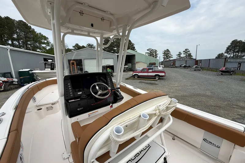 Slide: The Image of 2025 Robalo R232 Explorer boat parked outdoors. - 4
