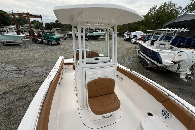 Slide: The Image of 2025 Robalo R232 Explorer boat in a parking area. - 9