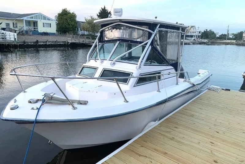 The Image of 1987 Grady-White Seafarer 226 boat docked by a serene waterfront. - 0