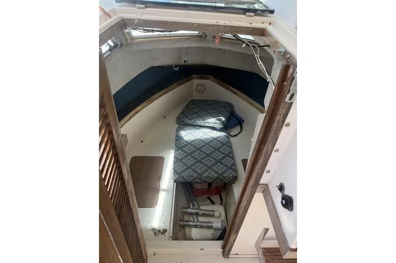 Slide: The Image of Interior cabin of 1987 Grady-White Seafarer 226 boat with cushions and storage. - 10