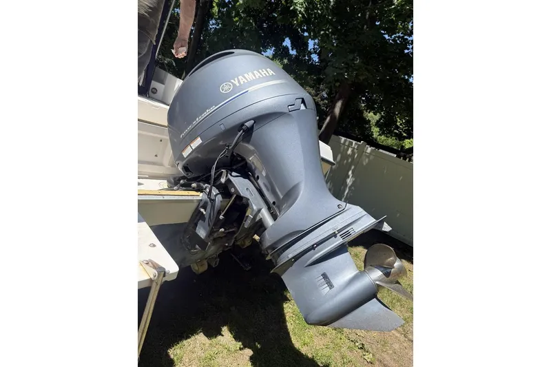 Slide: The Image of 1987 Grady-White Seafarer 226 with Yamaha outboard motor, parked on grass. - 5