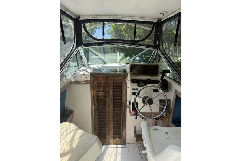 Slide: The Image of 1987 Grady-White Seafarer 226 boat interior with steering wheel and navigation equipment. - 6