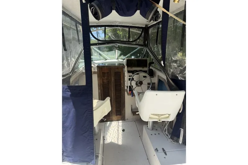 Slide: The Image of Interior of 1987 Grady-White Seafarer 226 boat with steering wheel and seating. - 7
