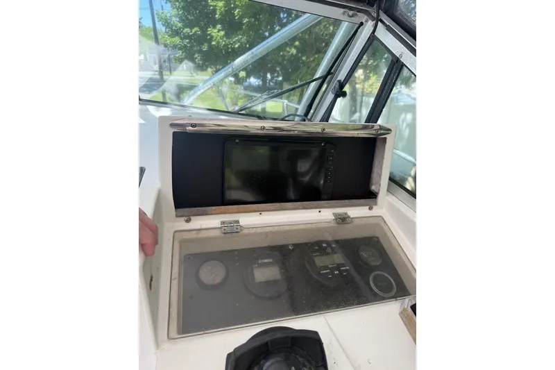 Slide: The Image of 1987 Grady-White Seafarer 226 boat dashboard with gauges and navigation equipment. - 9