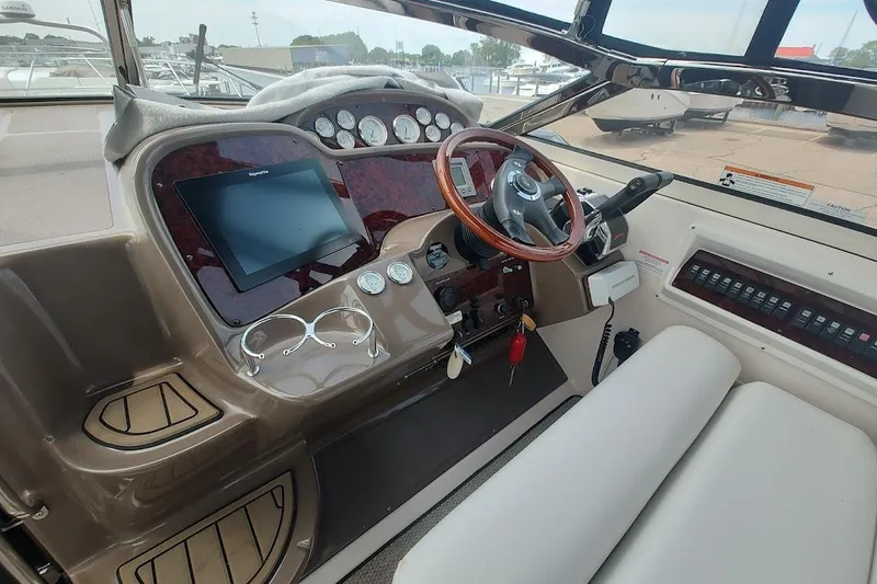 Slide: The Image of 2006 Regal Commodore 3560 IO helm with steering wheel, gauges, and navigation screen. - 10