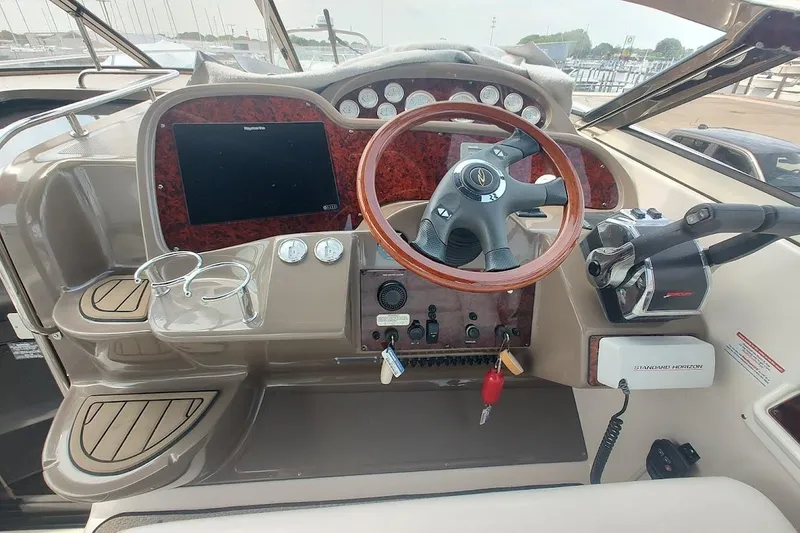 Slide: The Image of 2006 Regal Commodore 3560 IO boat dashboard with steering wheel and control panel. - 14