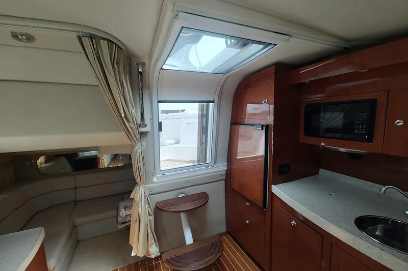 Slide: The Image of Interior of 2006 Regal Commodore 3560 IO yacht with kitchenette and seating area. - 19