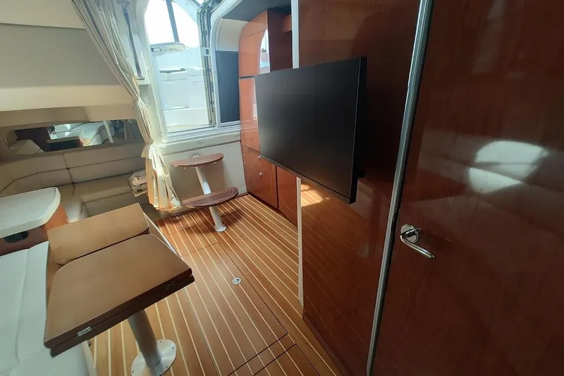Slide: The Image of Interior of 2006 Regal Commodore 3560 IO yacht with wood flooring and modern furnishings. - 23