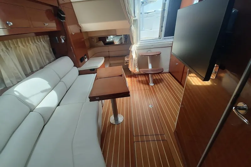 Slide: The Image of Luxurious interior of 2006 Regal Commodore 3560 IO yacht with elegant seating and wood flooring. - 24