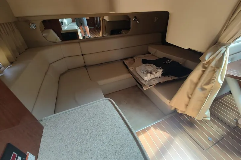 Slide: The Image of Interior of 2006 Regal Commodore 3560 IO yacht with beige seating and wooden flooring. - 25