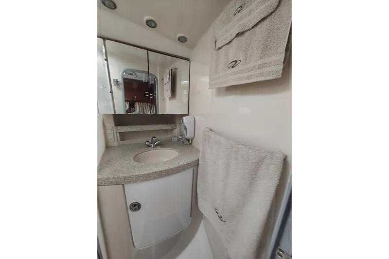 Slide: The Image of Bathroom interior of 2006 Regal Commodore 3560 IO yacht, featuring sink and towels. - 28