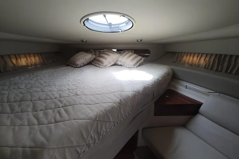 Slide: The Image of Luxurious cabin interior of 2006 Regal Commodore 3560 IO yacht with plush bedding. - 29